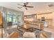 Bright and airy living room with an open floor plan and seamless access to both the kitchen and screened lanai at 11502 Golden Bay Pl, Bradenton, FL 34211