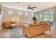 Inviting living room featuring wood-look floors, neutral walls, and comfortable seating near large sliding glass doors at 11502 Golden Bay Pl, Bradenton, FL 34211