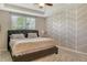 Serene main bedroom with decorative wall accent, tray ceiling, plush carpet and a large window at 11502 Golden Bay Pl, Bradenton, FL 34211