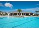 Community pool with sun loungers and palm trees offering a resort-style experience for residents at 11502 Golden Bay Pl, Bradenton, FL 34211