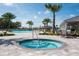 Resort-style pool area boasts a spa and palm trees, perfect for relaxation and outdoor enjoyment at 11502 Golden Bay Pl, Bradenton, FL 34211