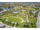 Breathtaking aerial view of the community, highlighting the park, tennis courts, and recreational facilities at 11714 Forest Park Cir, Bradenton, FL 34211