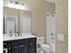Bathroom features a vanity with sink, commode, and shower over tub at 11714 Forest Park Cir, Bradenton, FL 34211