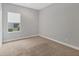 Bedroom with neutral walls, window, and carpeting at 11714 Forest Park Cir, Bradenton, FL 34211
