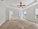 Spacious bedroom featuring a ceiling fan, neutral walls, and an en-suite bathroom and walk-in closet at 11714 Forest Park Cir, Bradenton, FL 34211