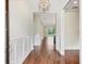 Bright foyer with hardwood flooring, decorative wainscoting, and an elegant light fixture at 11714 Forest Park Cir, Bradenton, FL 34211