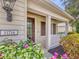 Inviting front porch with elegant architectural details and lush, colorful landscaping at 11714 Forest Park Cir, Bradenton, FL 34211