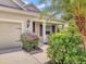 Charming front porch featuring manicured landscaping and a well-lit entryway at 11714 Forest Park Cir, Bradenton, FL 34211