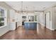 Bright kitchen with white cabinets, a blue island, stainless steel appliances, and stylish light fixtures at 11714 Forest Park Cir, Bradenton, FL 34211