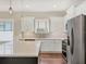 Bright kitchen with white cabinets, stainless steel appliances, and a gray island with white countertops at 11714 Forest Park Cir, Bradenton, FL 34211