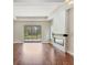 Spacious living room featuring hardwood floors, a modern fireplace, and sliding glass doors to the outdoor area at 11714 Forest Park Cir, Bradenton, FL 34211