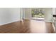 Open living room with hardwood flooring, shiplap accent wall, fireplace, and view to the screened patio at 11714 Forest Park Cir, Bradenton, FL 34211