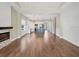 Bright, open-concept living space with hardwood floors, a modern fireplace, and view to the kitchen and dining area at 11714 Forest Park Cir, Bradenton, FL 34211