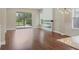 Spacious living room with a fireplace, large windows, and wood floors at 11714 Forest Park Cir, Bradenton, FL 34211