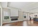 Open-concept living room featuring hardwood floors, a modern fireplace, and view to the kitchen at 11714 Forest Park Cir, Bradenton, FL 34211