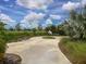 Inviting community park featuring a concrete path with benches, surrounded by greenery and landscaping at 11714 Forest Park Cir, Bradenton, FL 34211