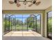 Screened patio featuring a ceiling fan and views of the lawn and landscaping at 11714 Forest Park Cir, Bradenton, FL 34211