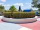 Community sculpture in a landscaped roundabout with manicured shrubs and shade structure at 11714 Forest Park Cir, Bradenton, FL 34211