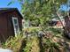 Lush backyard scene with trees, shed, and patio, creating a relaxing and private outdoor oasis at 12127 Hunter Ave, Port Charlotte, FL 33953