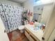 Cozy bathroom featuring a shower-tub combo, patterned shower curtain, and vanity with sink at 12127 Hunter Ave, Port Charlotte, FL 33953
