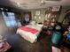 Comfortable bedroom with dark tile flooring, filled with personal items and unique decor at 12127 Hunter Ave, Port Charlotte, FL 33953