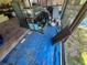 Patio area under construction with aquariums, a blue tarp, and a view of the outdoors at 12127 Hunter Ave, Port Charlotte, FL 33953