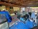 A patio area under construction with stacked aquariums, a blue tarp, and unfinished walls at 12127 Hunter Ave, Port Charlotte, FL 33953