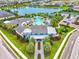 Aerial view of clubhouse with luxurious pool, seating and manicured landscaping at 13849 Old Creek Ct, Parrish, FL 34219