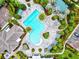 Aerial view of a community pool featuring a unique shape, seating areas, and lush landscaping at 13849 Old Creek Ct, Parrish, FL 34219
