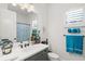 Bright bathroom features a single sink vanity with white countertop and blue accents at 13849 Old Creek Ct, Parrish, FL 34219