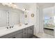 Bathroom with double vanity and a view to the bedroom at 13849 Old Creek Ct, Parrish, FL 34219