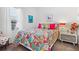 Bedroom with colorful decor, a bright comforter, and a large window at 13849 Old Creek Ct, Parrish, FL 34219