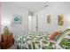 Sunlit bedroom with a botanical themed bed, and a turtle wall decor at 13849 Old Creek Ct, Parrish, FL 34219