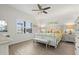 Bright bedroom with white-washed wood accent wall, large window, and stylish decor at 13849 Old Creek Ct, Parrish, FL 34219