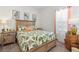 Bright bedroom with botanical theme bedding, a wooden headboard, and a side table at 13849 Old Creek Ct, Parrish, FL 34219