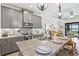 Open-concept kitchen boasts gray cabinets, granite countertops, stainless appliances, and an island overlooking the living area at 13849 Old Creek Ct, Parrish, FL 34219