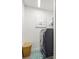Laundry room featuring front load washer and dryer with window and a wicker basket at 13849 Old Creek Ct, Parrish, FL 34219