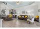 Open-concept living room showcases the kitchen with gray cabinets and stainless appliances at 13849 Old Creek Ct, Parrish, FL 34219