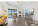 Bright living room featuring water views, stylish furniture, fireplace, and media center at 13849 Old Creek Ct, Parrish, FL 34219