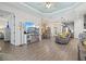 Open-concept living space with hardwood floors, a kitchen view, and elegant decor at 13849 Old Creek Ct, Parrish, FL 34219