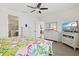 Main bedroom features light-colored furniture and access to the main bathroom at 13849 Old Creek Ct, Parrish, FL 34219