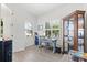 Bright office with a wooden desk, window shutters, and stylish display cabinet, creating a functional workspace at 13849 Old Creek Ct, Parrish, FL 34219