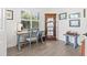 Bright office space featuring a wooden desk, shutters, and decorative display cabinet at 13849 Old Creek Ct, Parrish, FL 34219