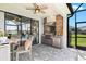 Outdoor kitchen with a built in grill and counter space under covered patio at 13849 Old Creek Ct, Parrish, FL 34219