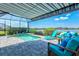 Screened-in pool area with sun shelf, and comfortable seating for relaxation, offering picturesque lake views at 13849 Old Creek Ct, Parrish, FL 34219
