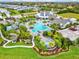Aerial view of a community pool surrounded by lush landscaping and resort-style amenities at 13849 Old Creek Ct, Parrish, FL 34219