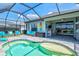 Inviting screened-in pool area features a sun shelf, colorful decor, outdoor bar and seating with lake views at 13849 Old Creek Ct, Parrish, FL 34219