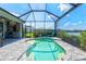 Bright sunlit screened-in pool with outdoor kitchen, offering a refreshing escape with lake views at 13849 Old Creek Ct, Parrish, FL 34219