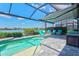 Inviting screened-in pool area with sun shelf, featuring comfortable seating, and tranquil lake views at 13849 Old Creek Ct, Parrish, FL 34219