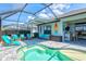 Inviting screened-in pool with a sun shelf, comfortable seating and decor in an outdoor living space at 13849 Old Creek Ct, Parrish, FL 34219